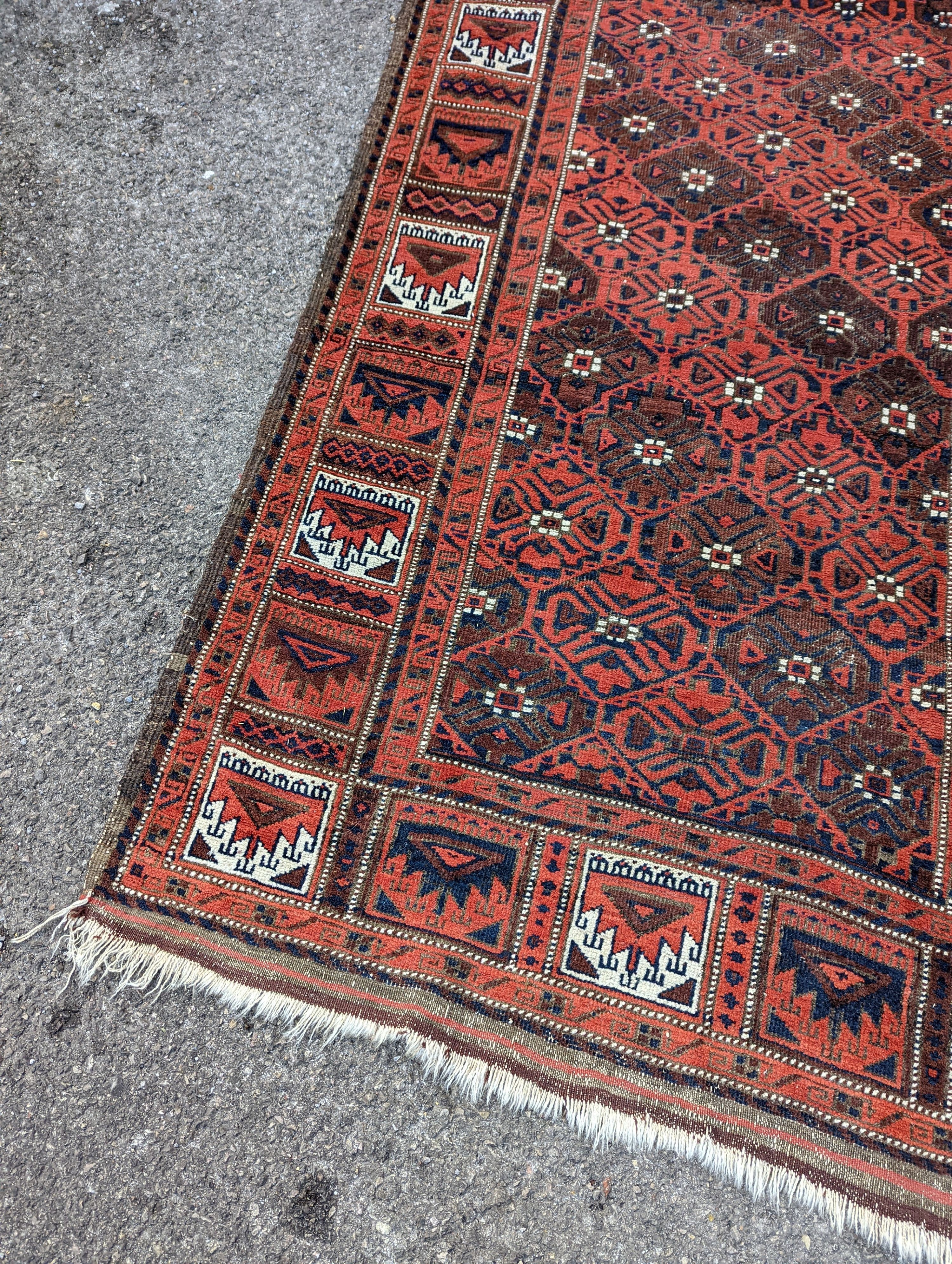 A Turkish red ground rug, 212 x 106cm